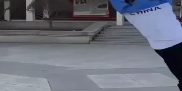 Funny fail video showing a man slipping and falling in public while people react in shock and laughter