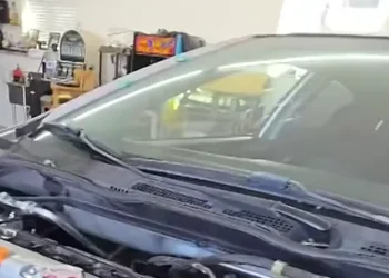 Mechanic fail video showing a garage accident with a car falling from a lift and a shocked mechanic