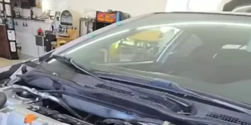 Mechanic fail video showing a garage accident with a car falling from a lift and a shocked mechanic